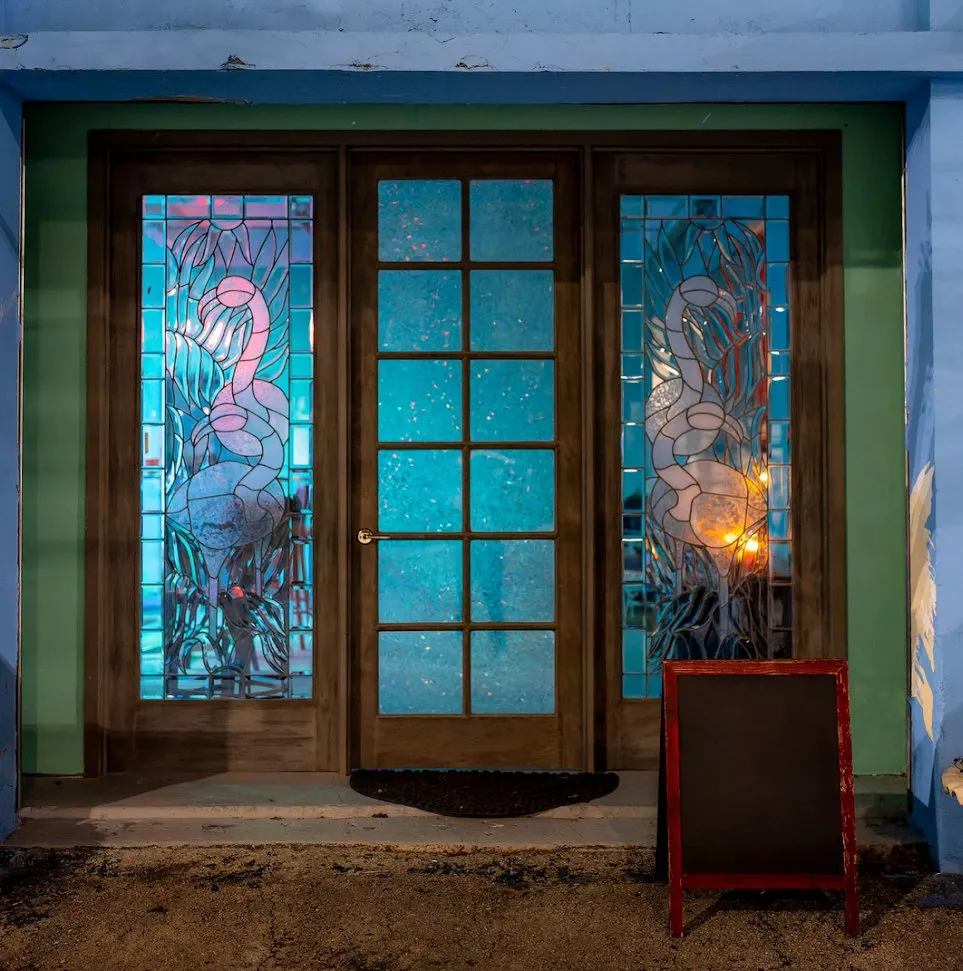 The stained glass flamingo doors at Dear Eleanor